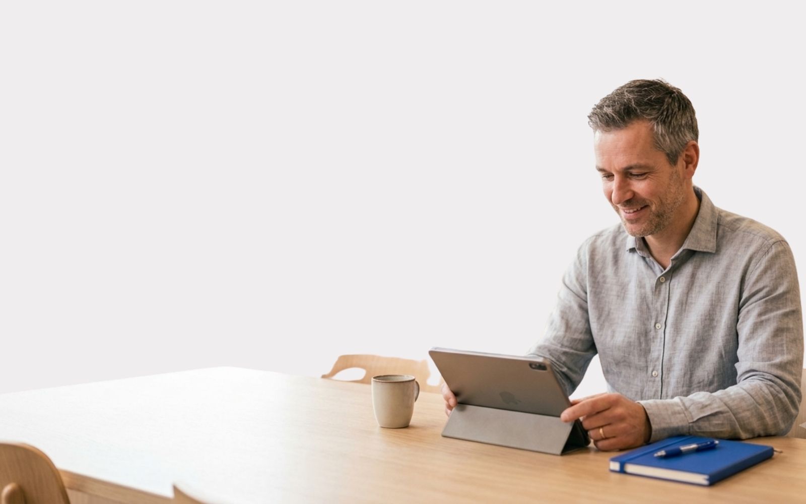 Docent kijkt op tablet in de docentenkamer
